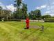 A red fire hydrant sits between manicured lawns in a fenced dog park at 1980 Great Ridge Pkwy, Chapel Hill, NC 27516