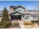 Charming two-story home featuring a welcoming front porch, landscaped yard, stone accents, and solar panels at 1980 Great Ridge Pkwy, Chapel Hill, NC 27516