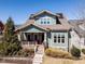 Charming two-story home featuring a welcoming front porch, landscaped yard, stone accents, and solar panels at 1980 Great Ridge Pkwy, Chapel Hill, NC 27516