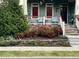 Inviting front porch with decorative railing and stone accents surrounded by lush landscaping at 1980 Great Ridge Pkwy, Chapel Hill, NC 27516