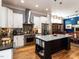 Open kitchen with stainless appliances, island with granite countertop, adjacent to dining area at 1980 Great Ridge Pkwy, Chapel Hill, NC 27516