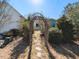 Stone pathway leading to the house, surrounded by mature trees and landscaping at 1980 Great Ridge Pkwy, Chapel Hill, NC 27516