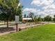 Community playground surrounded by lush greenery, featuring play structures, swings, and a picnic pavilion at 1980 Great Ridge Pkwy, Chapel Hill, NC 27516