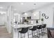 A stylish kitchen features stainless steel appliances and a granite countertop island with bar stools at 206 Drayton Hall Ln, Sanford, NC 27330