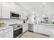 Modern kitchen features stainless steel appliances, granite countertops, and white cabinets at 206 Drayton Hall Ln, Sanford, NC 27330