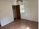 Bedroom featuring laminate flooring, a window, a closet and neutral walls at 2102 Michael Ln, Smithfield, NC 27577