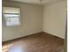 Cozy bedroom with laminate flooring, a window with blinds, and ample natural light at 2102 Michael Ln, Smithfield, NC 27577