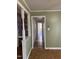 Hallway with an open view of rooms, wood flooring, and natural light, ready to update at 2102 Michael Ln, Smithfield, NC 27577