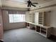 Spacious living room with a large window, ceiling fan and built-in shelving ready for updates at 2102 Michael Ln, Smithfield, NC 27577