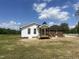 Back view of home showing brick and white siding with a small porch and wooden stairs at 2130 Pearidge Rd, Angier, NC 27501