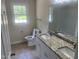 Bright bathroom with a double vanity with granite countertops and a large mirror at 2130 Pearidge Rd, Angier, NC 27501