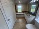 Bright bathroom with tiled floor, soaking tub, a double vanity with granite countertops and a large mirror at 2130 Pearidge Rd, Angier, NC 27501