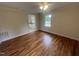 This bedroom features hardwood floors, neutral walls, and a window, adjacent to a bathroom at 2130 Pearidge Rd, Angier, NC 27501