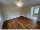 Bedroom with hardwood floors, neutral walls, a ceiling fan, and an ensuite bathroom at 2130 Pearidge Rd, Angier, NC 27501