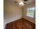 Well-lit bedroom with hardwood floors, neutral walls, a ceiling fan and large window at 2130 Pearidge Rd, Angier, NC 27501