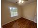 Well-lit bedroom with hardwood floors, neutral walls, a ceiling fan and large window at 2130 Pearidge Rd, Angier, NC 27501