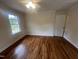This bedroom features hardwood floors, neutral walls, and a window with a view of trees at 2130 Pearidge Rd, Angier, NC 27501