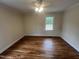 Bright bedroom with hardwood flooring, a ceiling fan, and a window offering a pleasant view at 2130 Pearidge Rd, Angier, NC 27501
