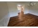 Hardwood floors grace this dining room, connected to the kitchen through an open doorway at 2130 Pearidge Rd, Angier, NC 27501