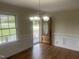 Dining room featuring hardwood floors, chandelier, and wainscotting at 2130 Pearidge Rd, Angier, NC 27501