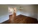 Inviting dining area with hardwood floors, elegant chandelier, and seamless flow to the kitchen at 2130 Pearidge Rd, Angier, NC 27501