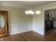Dining room featuring hardwood floors, chandelier, and wainscotting at 2130 Pearidge Rd, Angier, NC 27501
