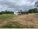 View of the exterior highlighting brick and siding, complemented by a spacious, landscaped front yard at 2130 Pearidge Rd, Angier, NC 27501