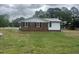 Side view of the home with white siding and black shutters at 2130 Pearidge Rd, Angier, NC 27501