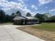 Brick home showing a concrete driveway and metal roof at 2130 Pearidge Rd, Angier, NC 27501