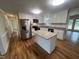 Modern kitchen with stainless steel appliances, granite countertops, an island, and hardwood floors at 2130 Pearidge Rd, Angier, NC 27501