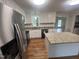 Updated kitchen features stainless steel appliances, a functional island, and generous counter space at 2130 Pearidge Rd, Angier, NC 27501