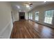 Large living room showcasing hardwood flooring, a brick fireplace, and multiple windows for ample light at 2130 Pearidge Rd, Angier, NC 27501