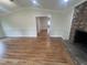 Spacious living room with a fireplace, wood floors, and seamless flow to adjoining rooms at 2130 Pearidge Rd, Angier, NC 27501