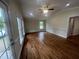 Bright living room with hardwood floors and vaulted ceilings, illuminated by recessed lights and natural light at 2130 Pearidge Rd, Angier, NC 27501