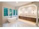Luxurious bathroom featuring a freestanding tub and dual vanity at 2200 Paddstowe Main Way, Wake Forest, NC 27587