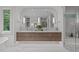 Spacious bathroom featuring double sinks, marble floors, and a walk-in shower at 2200 Paddstowe Main Way, Wake Forest, NC 27587