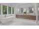 Spa bathroom featuring a soaking tub, marble floors, and wood vanity at 2200 Paddstowe Main Way, Wake Forest, NC 27587