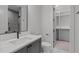 Modern bathroom featuring a sleek vanity, patterned tile flooring, and glass-enclosed shower at 2200 Paddstowe Main Way, Wake Forest, NC 27587