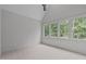 Bedroom with light gray walls, carpeted flooring and three windows offering great natural light at 2200 Paddstowe Main Way, Wake Forest, NC 27587