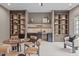 Bonus room features a custom bar with stylish shelving, a game table, and a comfortable seating area at 2200 Paddstowe Main Way, Wake Forest, NC 27587