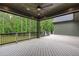 Wide outdoor deck with ceiling fan, exterior speakers, and backyard view at 2200 Paddstowe Main Way, Wake Forest, NC 27587