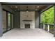 Cozy outdoor deck with stone fireplace and outdoor ceiling fan at 2200 Paddstowe Main Way, Wake Forest, NC 27587