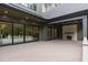 View of a spacious deck with a stone fireplace and sliding glass doors leading to the interior of the home at 2200 Paddstowe Main Way, Wake Forest, NC 27587