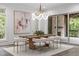 Elegant dining room with modern chandelier, wood table and view to outdoor at 2200 Paddstowe Main Way, Wake Forest, NC 27587