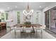 Modern dining room with stylish chandelier and ample natural light, adjacent to the kitchen area at 2200 Paddstowe Main Way, Wake Forest, NC 27587