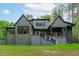 View of the back of the home showing an exterior staircase, deck, and covered patio at 2200 Paddstowe Main Way, Wake Forest, NC 27587