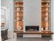Close up of modern fireplace with built in shelving and mantel at 2200 Paddstowe Main Way, Wake Forest, NC 27587
