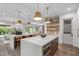 Kitchen featuring double islands, stainless steel appliances, and an open layout into the living room at 2200 Paddstowe Main Way, Wake Forest, NC 27587
