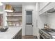 Kitchen with open shelving, stainless steel appliances, sink, and lots of natural light at 2200 Paddstowe Main Way, Wake Forest, NC 27587