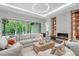 Bright living room with modern fireplace, large sectional, and sliding doors to the exterior at 2200 Paddstowe Main Way, Wake Forest, NC 27587